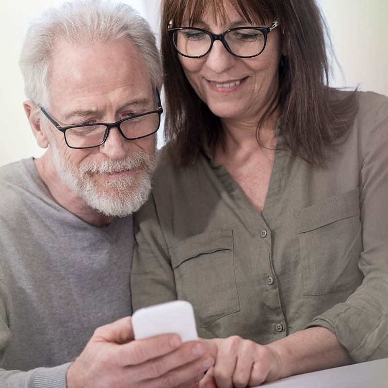 Patient and partner viewing smart phone